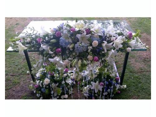 Mesa de vidrio con arreglo floral