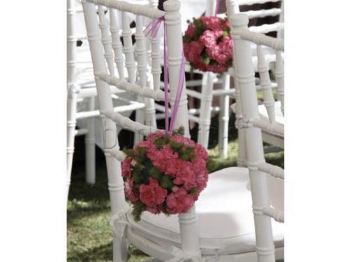 Sillas adornadas con flores rosas para ceremonia
